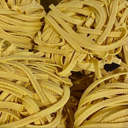 Hand-made tagliatelle nest of organic turmeric wheat